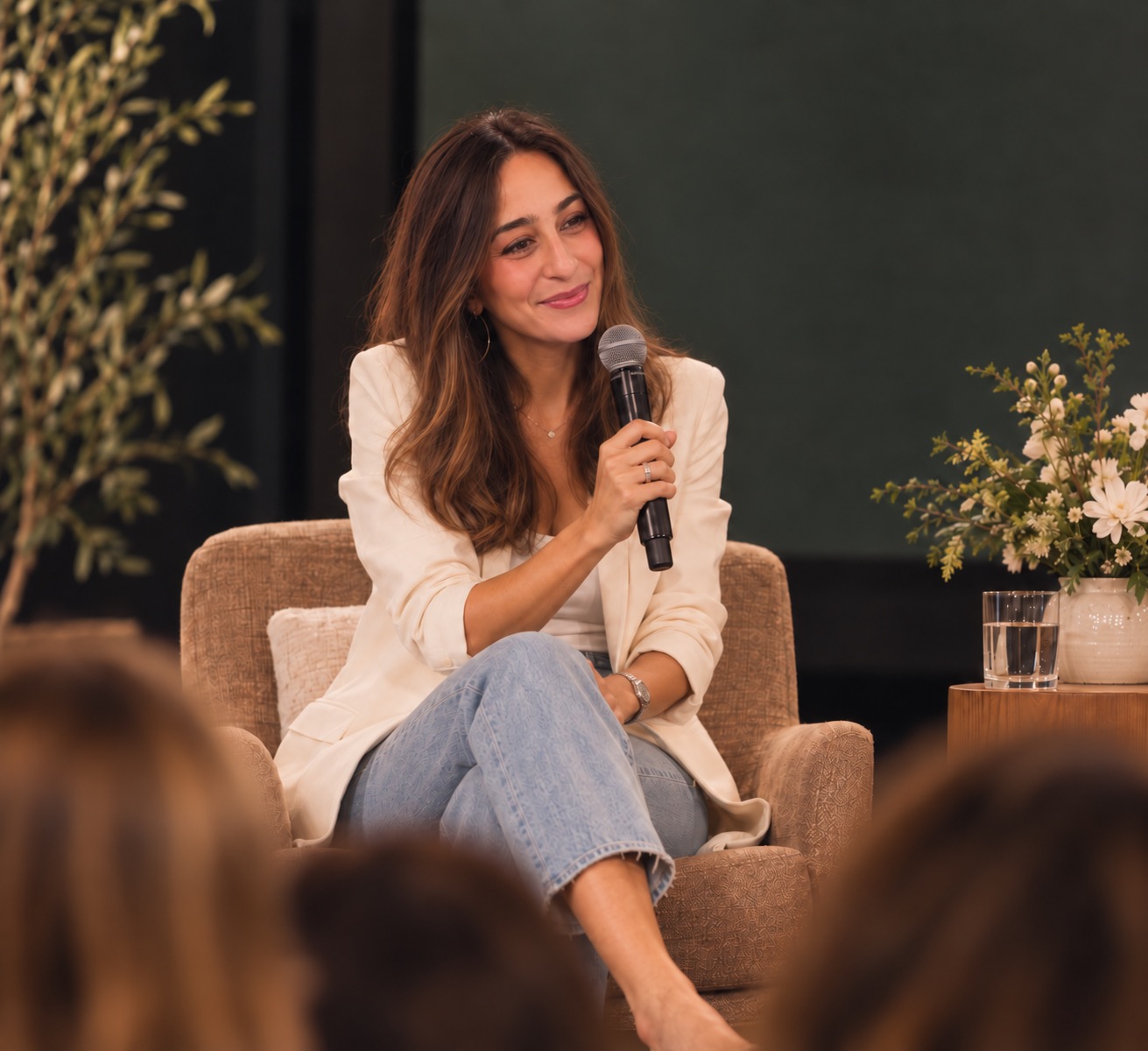 Desirae Terry seated on stage with a microphone during a fireside conversation