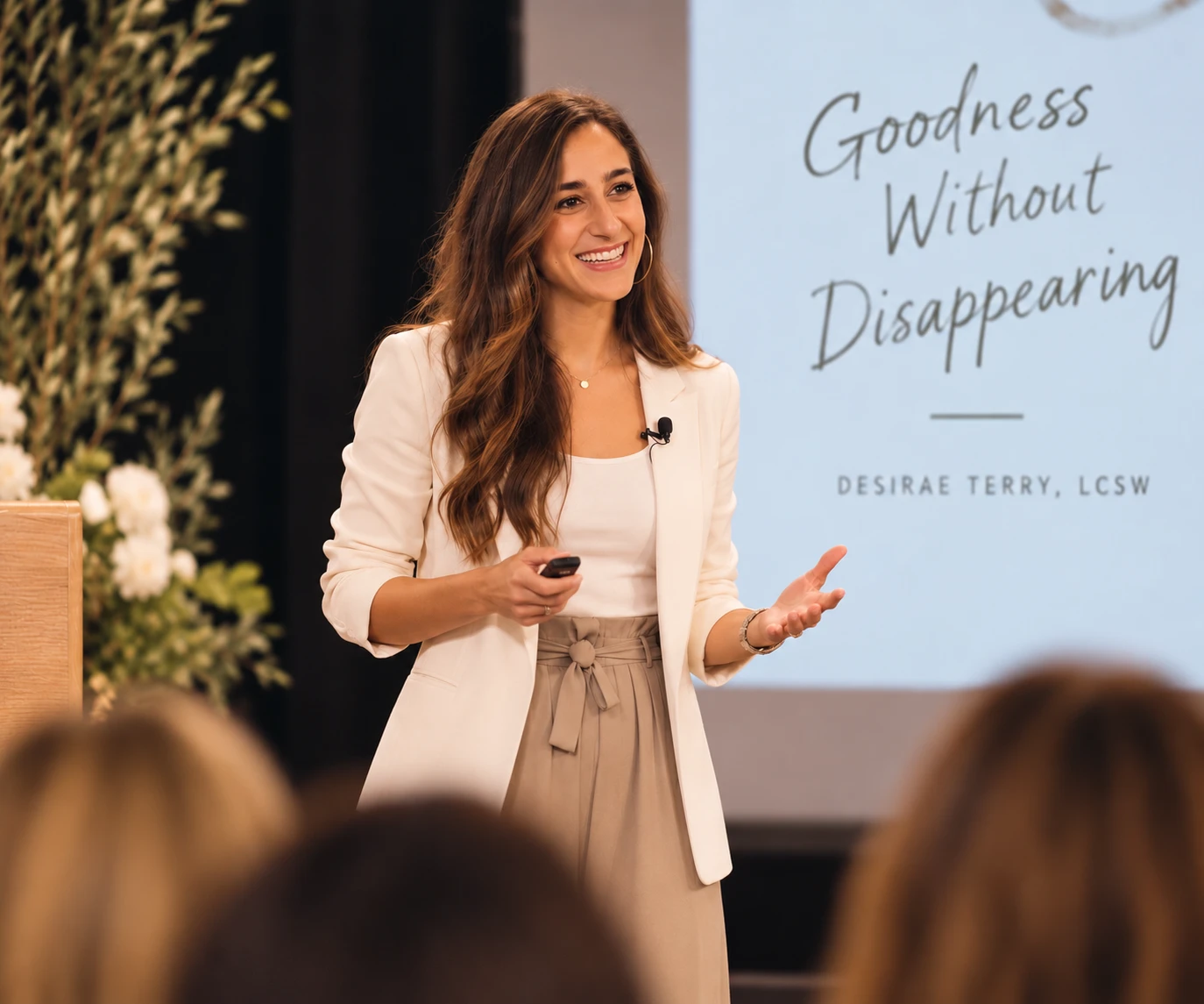 Desirae Terry speaking on stage in front of a slide reading &ldquo;Goodness Without Disappearing&rdquo;